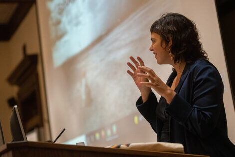 ValeriaLuiselli addresses faculty and staff seated from a podium in Kirby Hall of Civil Rights