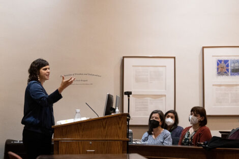 Valeria_Luiselli addresses faculty and staff seated from a podium in Kirby Hall of Civil Rights