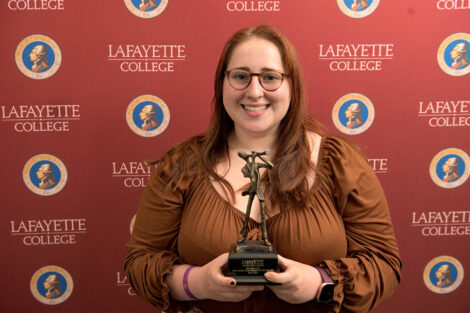 Meredith McGee ’23 holds award in front of Lafayette College backdrop