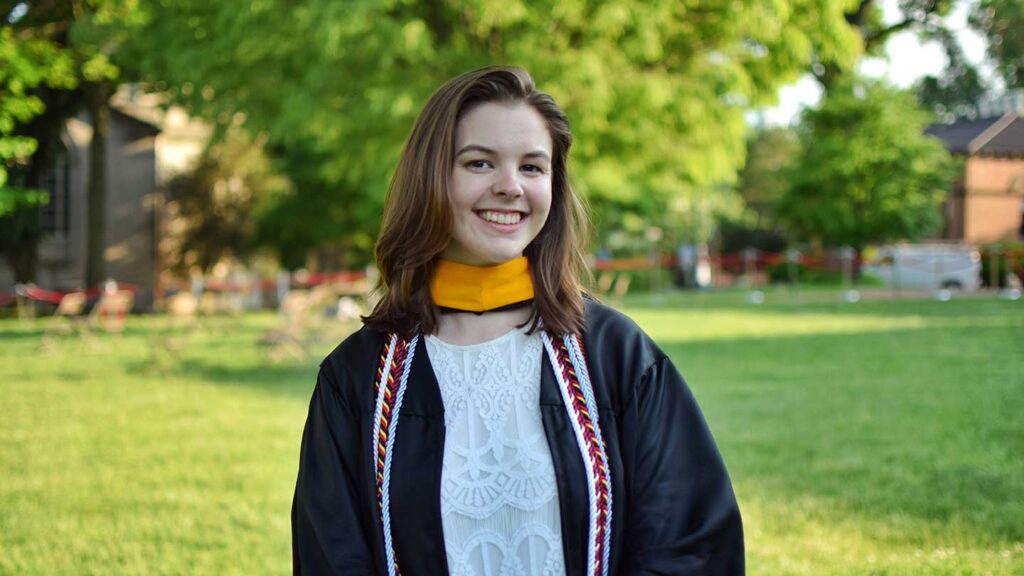 Class of 2022 valedictorian Celeste Fieberg wearing graduation gown on Lafayette campus