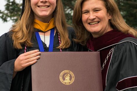 Elizabeth Good ’22 accepts her diploma from President Hurd