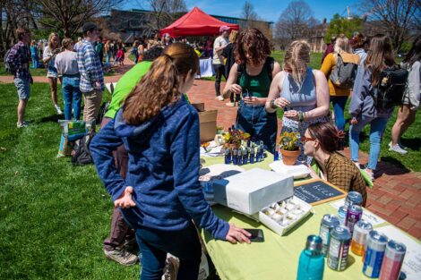 students gather around a table on the Quad