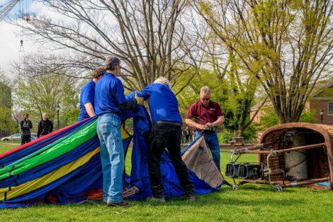 a group of workers assembling the hot air ballon on the Quad