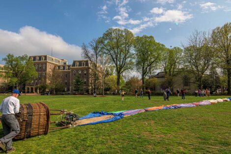 the deflated hot air balloon is stretched out on the Quad, Pardee in background