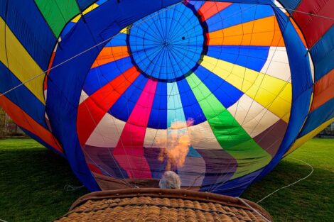 fire comes out of a basket up into a hot air balloon