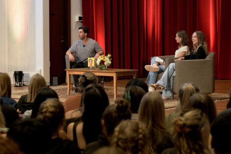 stage in Colton Chapel with Josh Peck and two students sitting in chairs talking