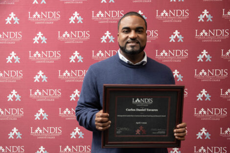 Carlos Tavares holds a Landis award against a Landis backdrop