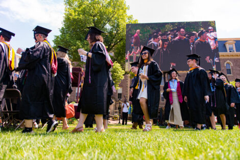 Graduates walk on to the Quad.