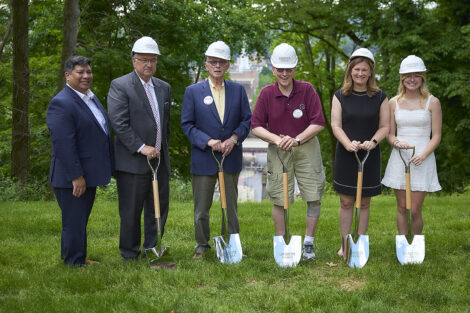 Six individuals, including Mayor Sal Panto and President Nicole Farmer Hurd, hold shovels while wearing construction hats.