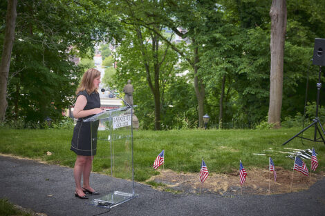 President Nicole Farmer Hurd speaks at a podium in front of a view of downtown Easton.