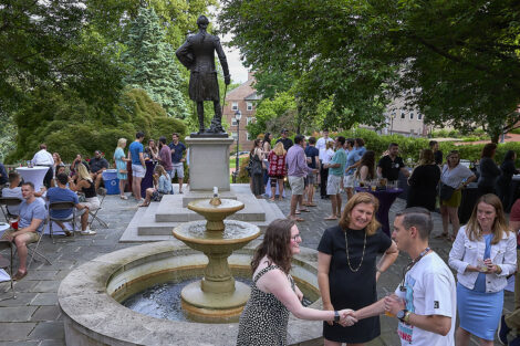 President Nicole Farmer Hurd talks with members of the Lafayette College community outside of the statue of the Marquis de Lafayette.
