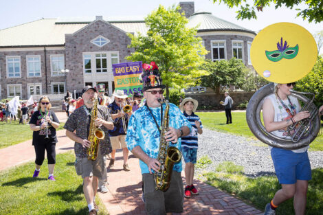 Musicians play in a parade across the Quad.