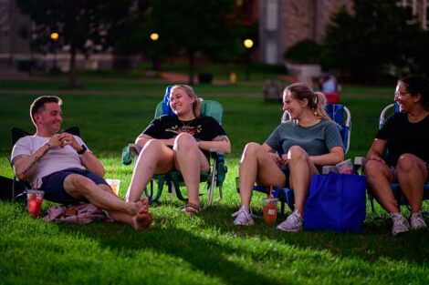 Lafayette students sitting and laughing on the lawn of the Quad awaiting the free outdoor movie screening