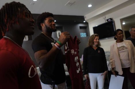 Lafayette football players and president Nicole Farmer Hurd surprising employees at Mojo Cafe with free Lafayette football jersey