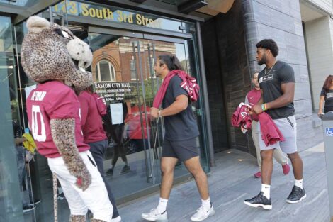 Lafayette football players walking into entrance to Easton Mayor Sal Panto's office building