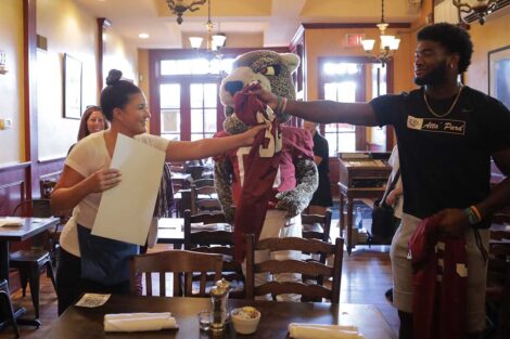Lafayette football player and Leopards mascot surprise employee at Sette Luna restaurant in Easton with free football tickets and jersey