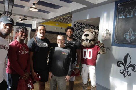 Lafayette football players pose with owner of Bayou restaurant in Easton