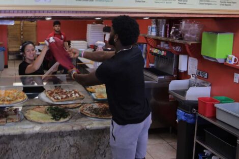 Lafayette football player surprising Picasso's pizzeria employee with a Lafayette football jersey