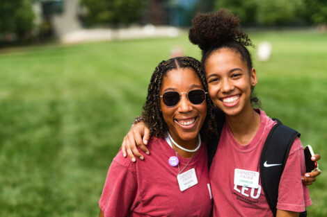 Two students smile on the Quad.
