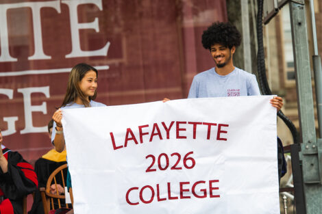 Two students hold the Class of 2026 banner.