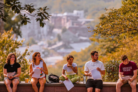 Students sit in front of a scenic view of downtown Easton.