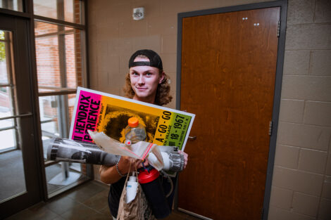 A student carries posters.