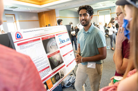 A student with their research presentation.