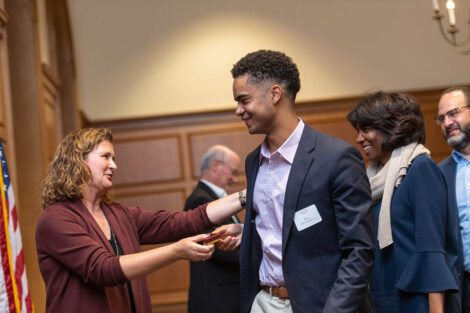President Nicole Farmer Hurd gives a pin to a student.