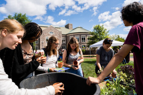 Students decorate pots on the Quad.