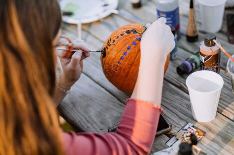 Close-up of student painting pumpkin on the Quad at Lafayette's Fall Fest 2022