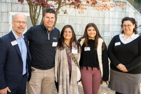 Six individuals stand outside before the Volunteer awards luncheon: Mike Summers, AVP, Gateway Career Center; Jacob Ruggles '01; Janel Ruggles, Mia Ruggles, and Alexis Leon, Gateway Career Center
