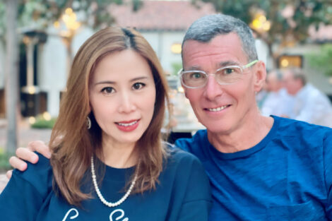 Juliet and Chip Bergh are both wearing blue shirts and smiling at the camera.