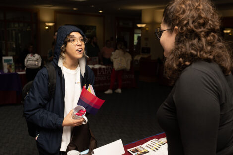A student attends the the National Coming Out Day Celebration and Resource Fair.