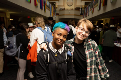 Two students hug at the the National Coming Out Day Celebration and Resource Fair.