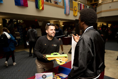 Tommy Lee talks with a student during the National Coming Out Day Celebration and Resource Fair.