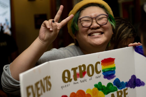 A student shows the peace sign as part of the National Coming Out Day Celebration and Resource Fair.