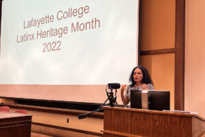 Gina Arias ’93 speaks in front of a podium.