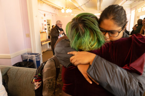 Two students embrace.