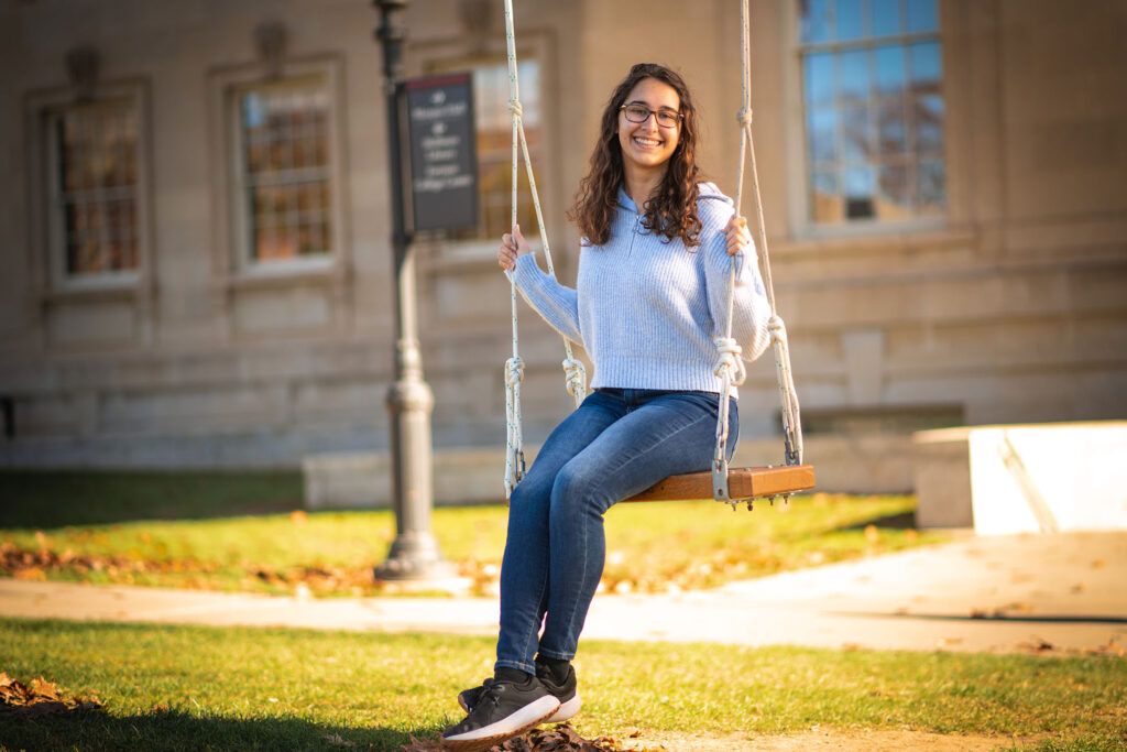 Elise Trocker sits on a swing.