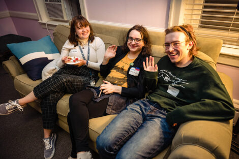 Lafayette students smile on a couch.