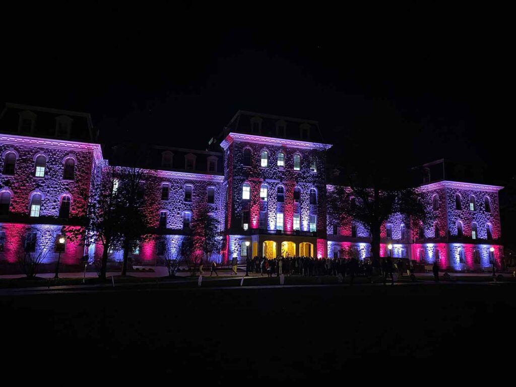 Pardee Hall is lit in maroon and white lights 