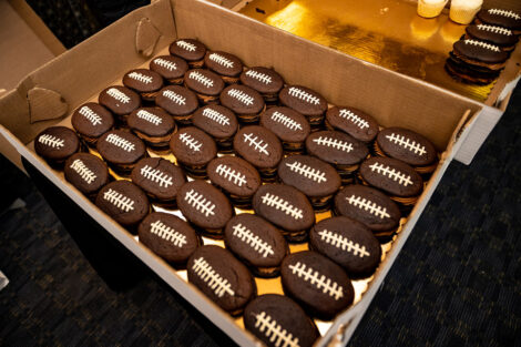 Box of football shaped desserts.