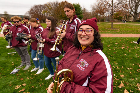 Members of the Pep Band smile.