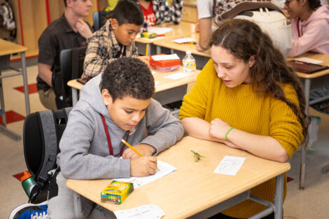 A Lafayette student teaches a child in a classroom.