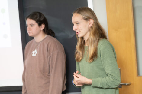 Lafayette students speak in front of a classroom.