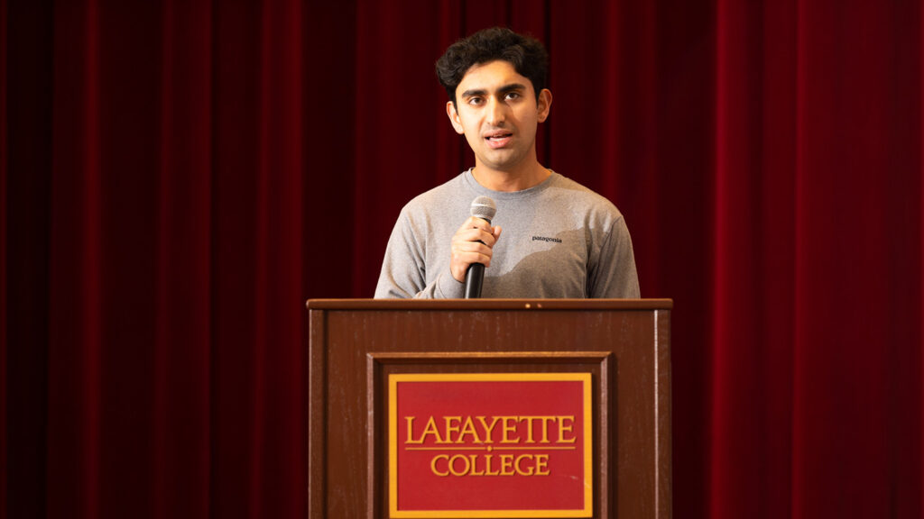 Shaan Shuster ’23 speaks at a podium.