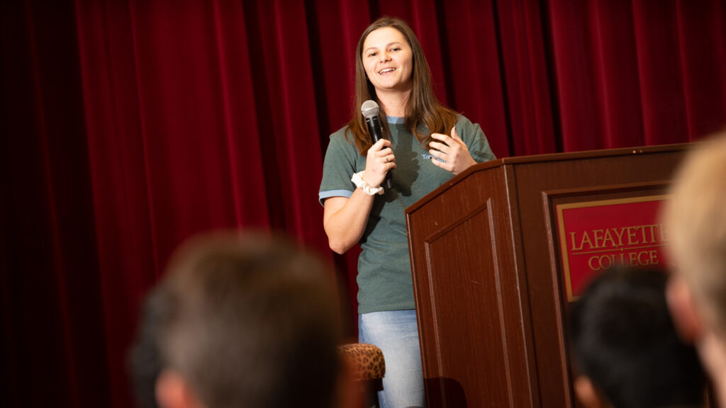 Lauren Maggio ’23 speaks at a podium.