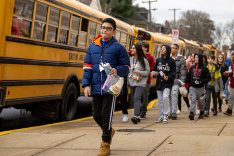 Students exit yellow buses.