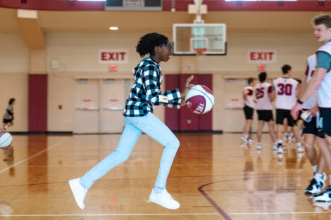 A student plays basketball