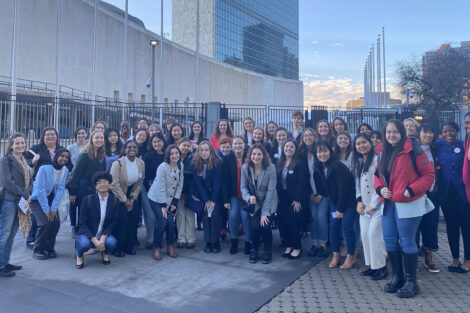 A large group in front of the U.N. building.